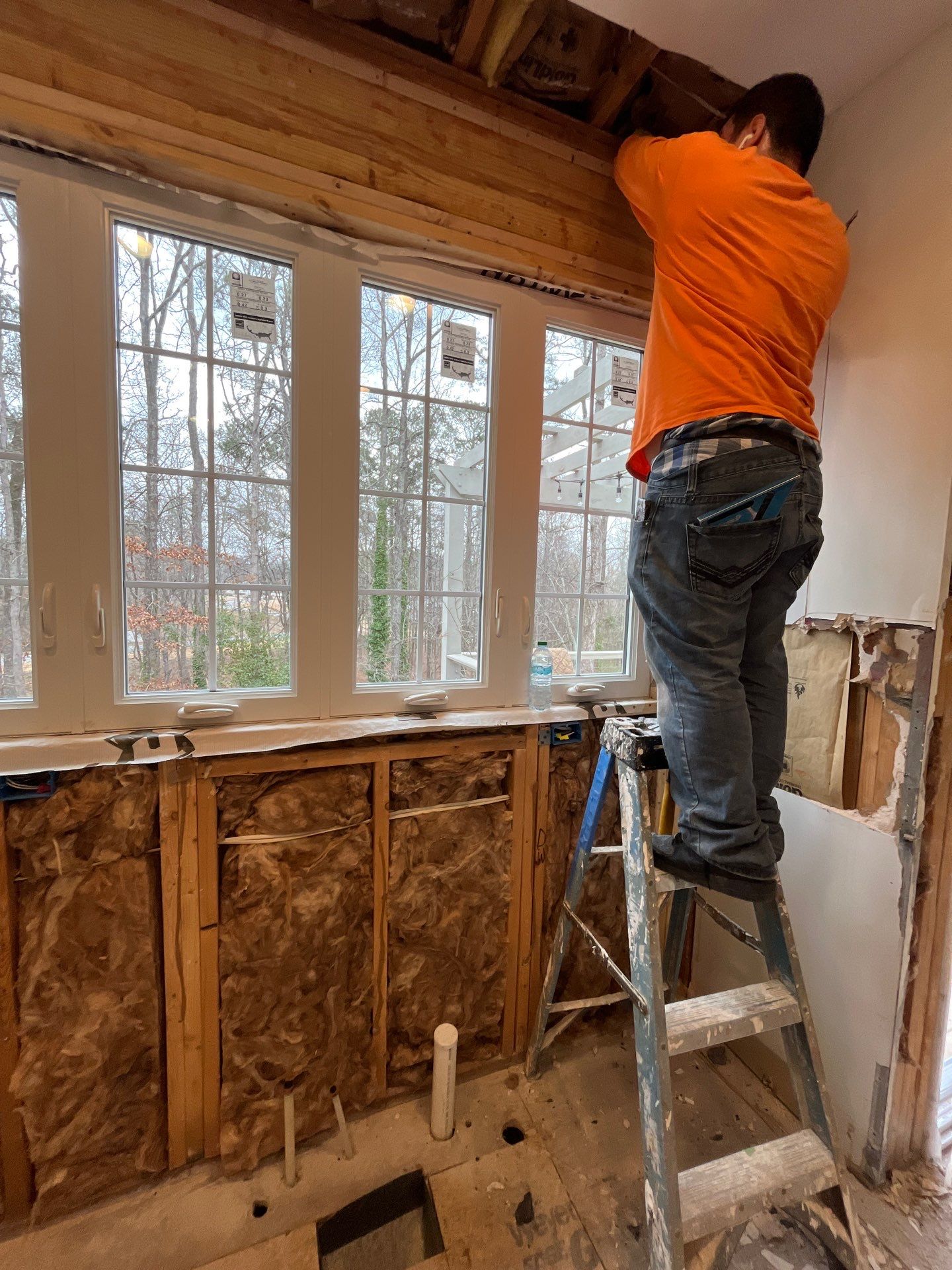 Contractor installing new windows during kitchen renovation โ exterior wall framed with new window set in opening โ Powder Springs, GA, Estate Solutions