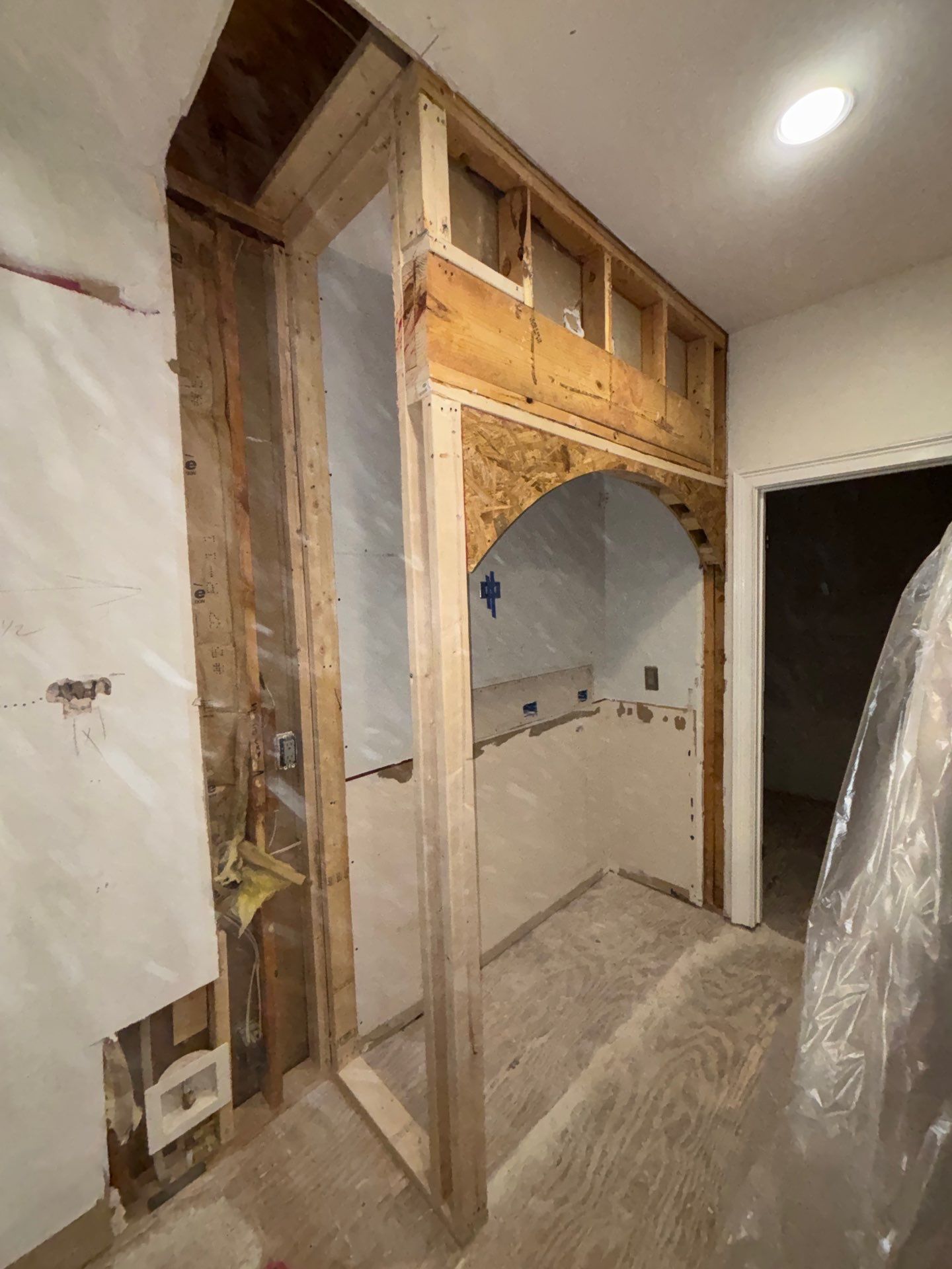 Wall framing for new arched pass-through opening during kitchen renovation โ structural framing and drywall in progress โ Powder Springs, GA, Estate Solutions