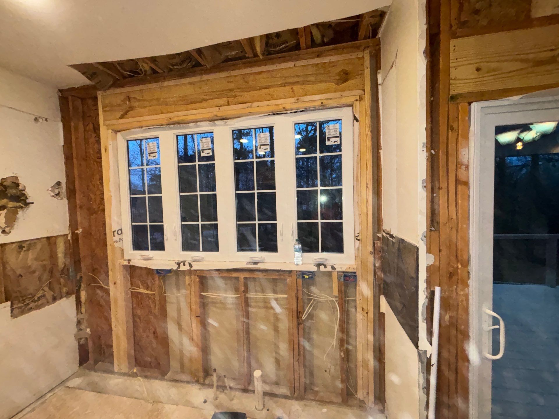 Kitchen exterior wall stripped to studs โ new window installed in framing, electrical rough-in during renovation โ Powder Springs, GA, Estate Solutions