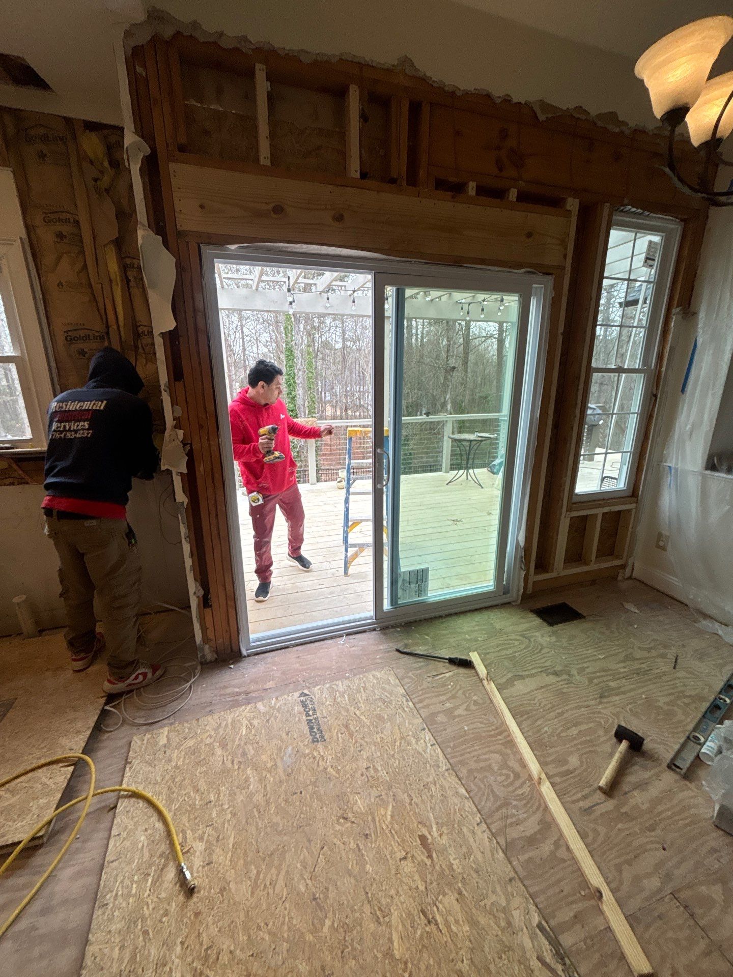 Contractors installing new sliding glass door from exterior โ framing and door installation during kitchen renovation โ Powder Springs, GA, Estate Solutions